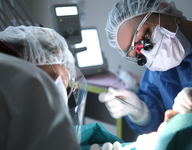 dentist performing osseous surgery