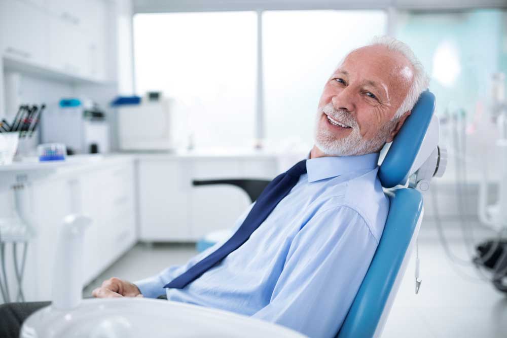 a patient smiling after his sedation dentistry
