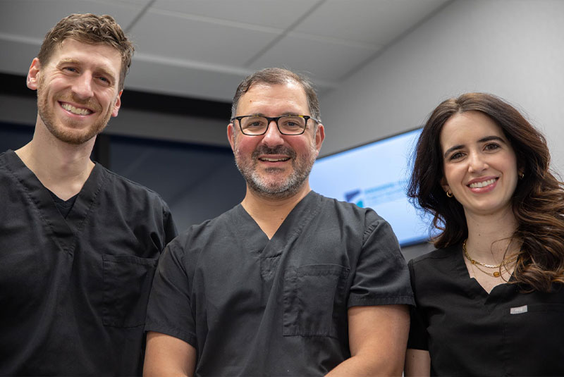 Dr. DeGroot, Dr. Mandelaris, and Dr. Botto Smiling