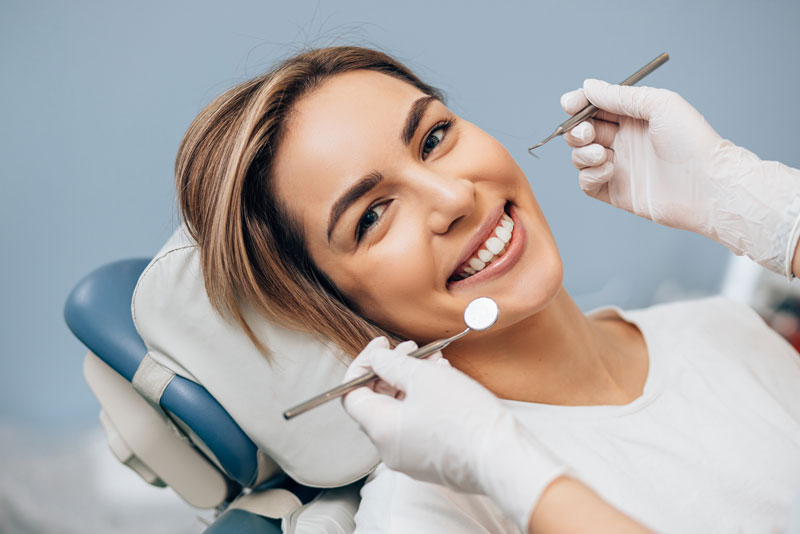 a dental implant patient smiling during an exam.